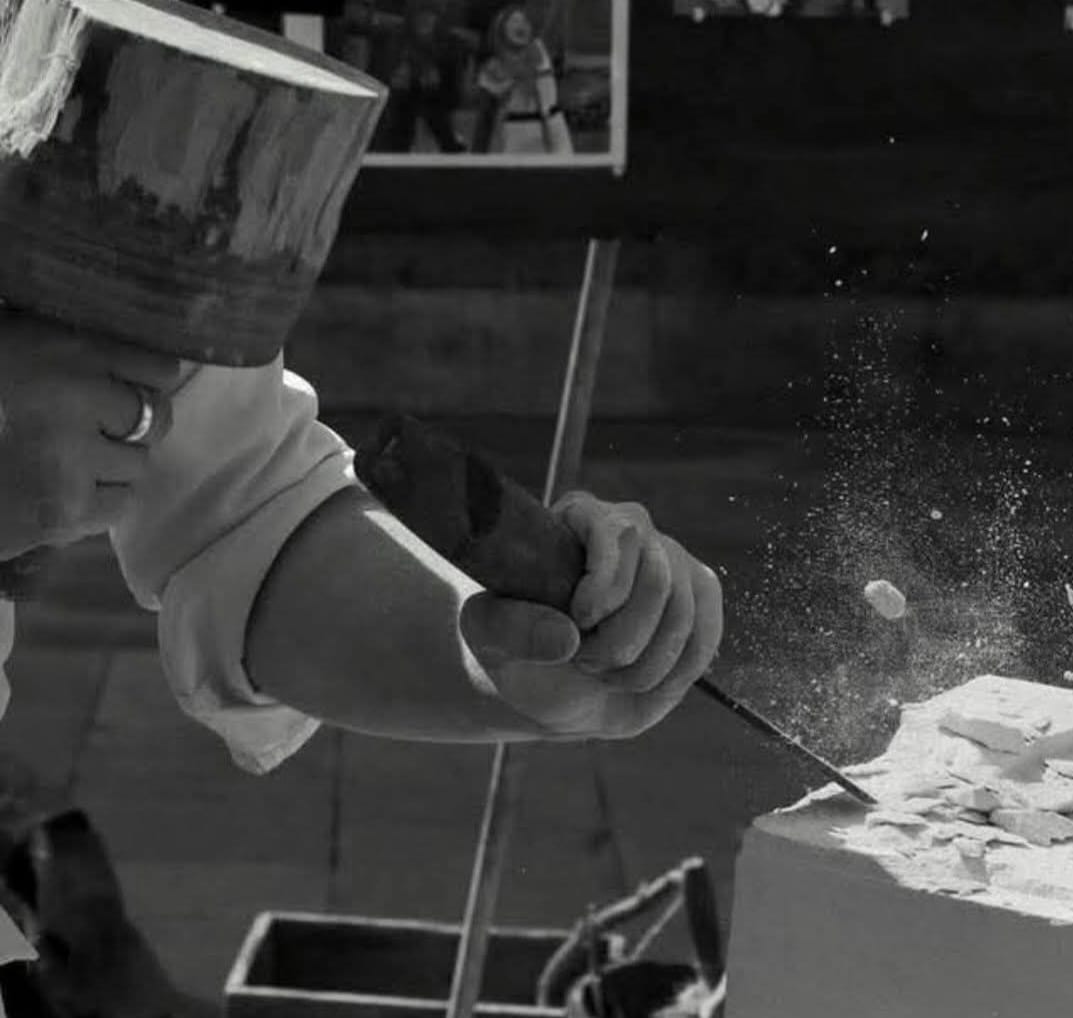 an action shot of a chisel striking a stone