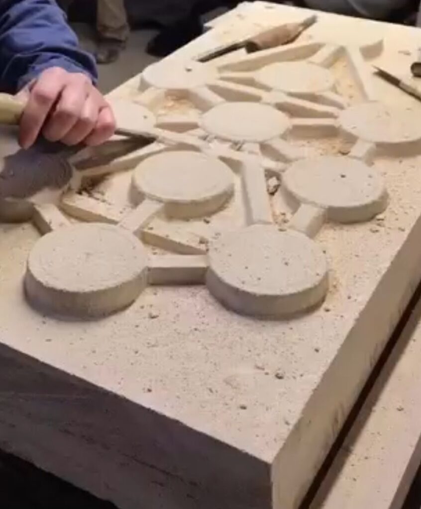 A stone tree of life being carved